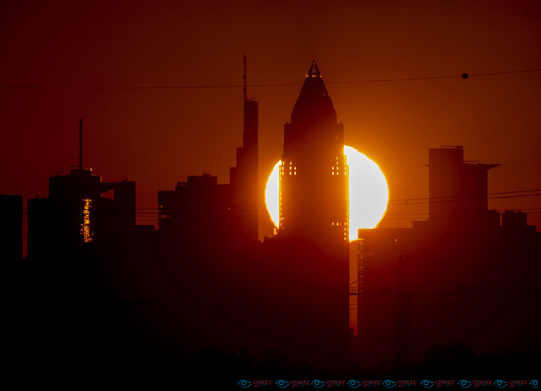 The sun rises behind the buildings of the banking district in Frankfurt, Germany, Wednesday, March. 9, 2022. (AP Photo/Michael Probst)