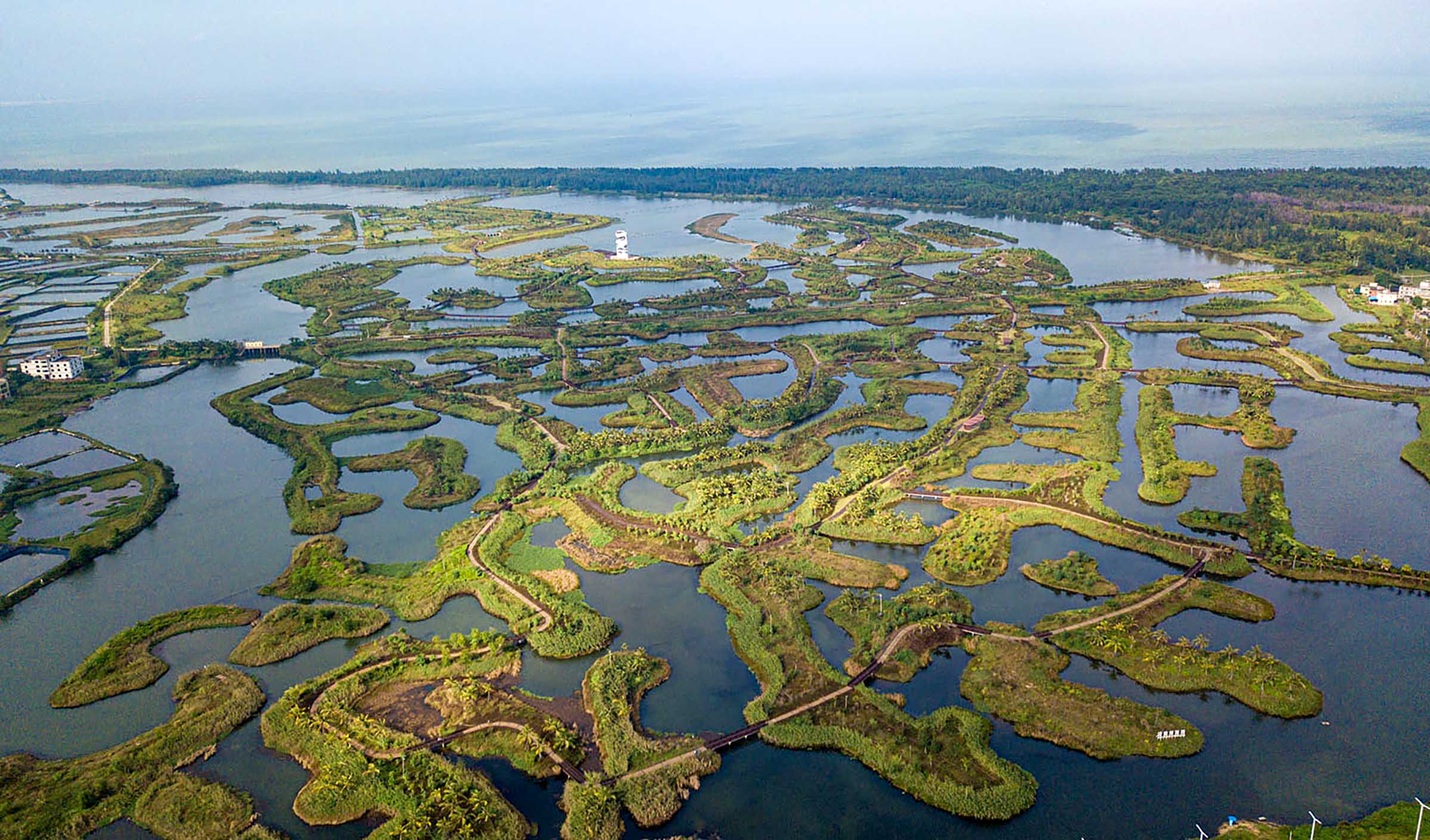 This aerial photo taken on Nov. 15, 2022 shows the scenery of the wetland of Maiya River in Haikou, south China's Hainan Province. Haikou was accredited by the Ramsar Convention as an international wetland city in 2018. The wetland coverage rate of the city is about 12.7 percent. (Xinhua/Pu Xiaoxu)