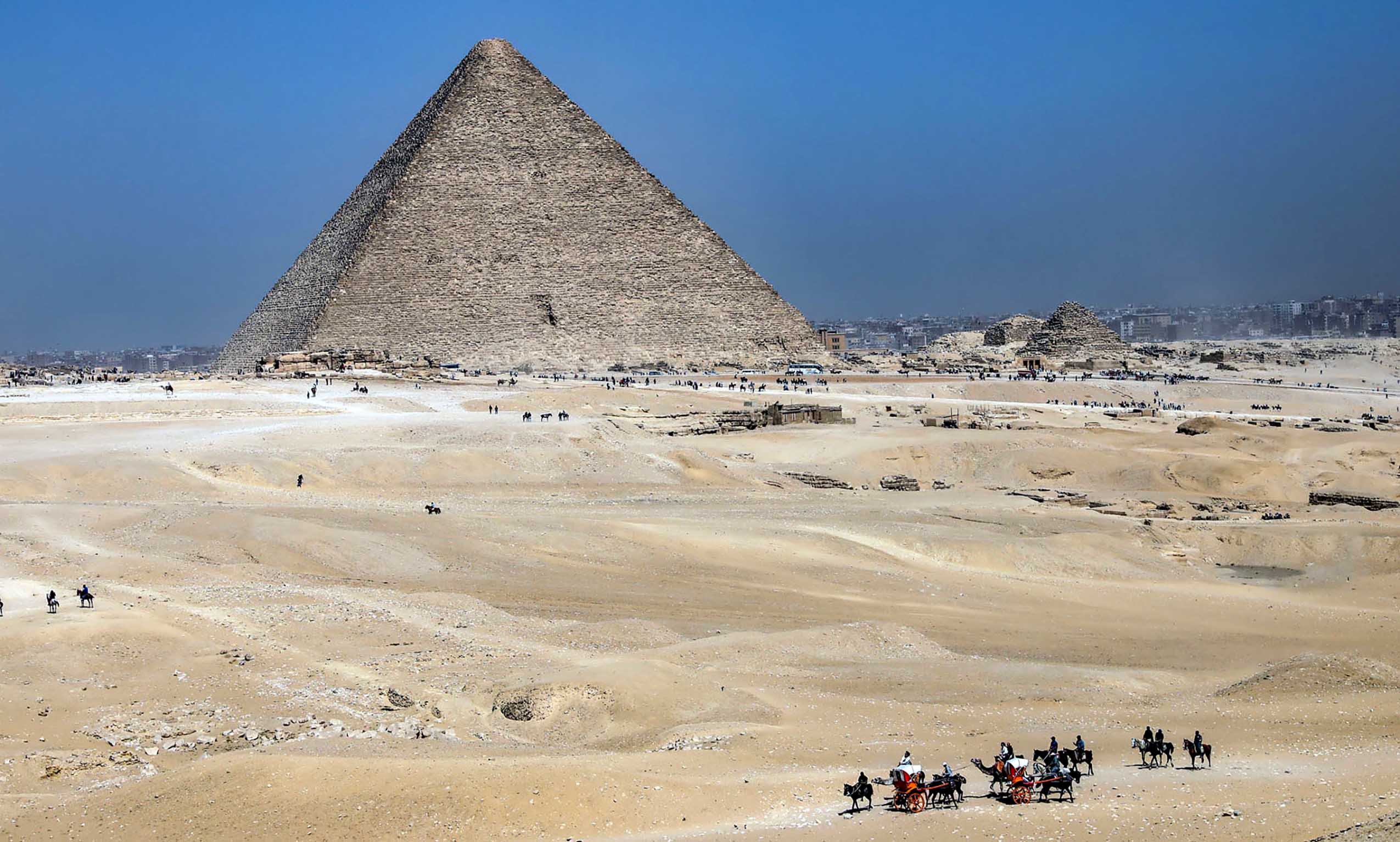 Tourists tour around the Khufu Pyramid in Giza, Egypt, on March 2, 2023. A discovery of a nine-meter-long and 2.10-meter-wide corridor behind the Great Pyramid of Giza, known as Khufu Pyramid, was announced on Thursday.   Egyptian Minister of Tourism and Antiquities Ahmed Issa said that 